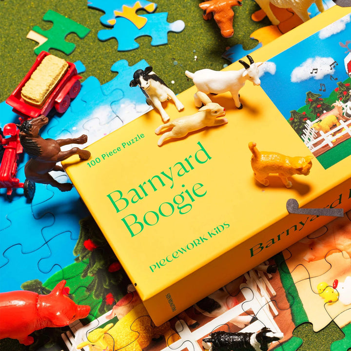 Jigsaw puzzle box titled 'Barnyard Boogie' with animal figurines and puzzle pieces.
