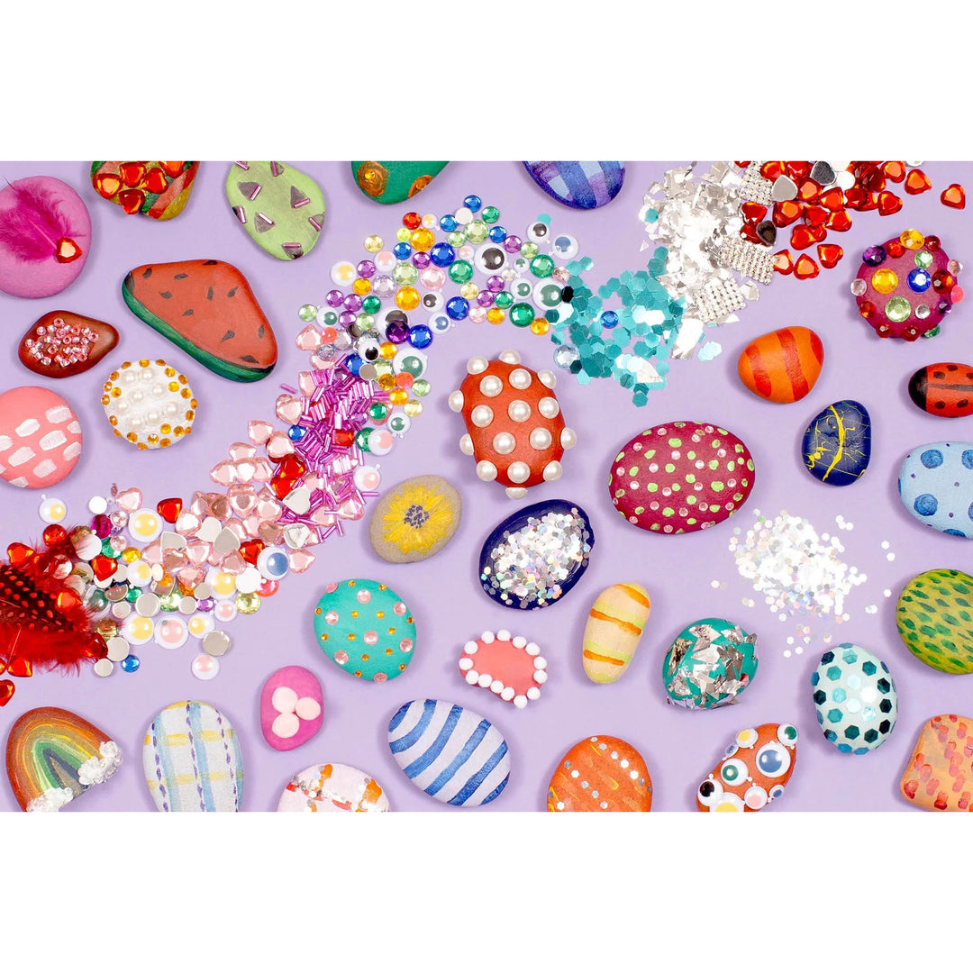 Colorful decorative stones and embellishments on a purple background