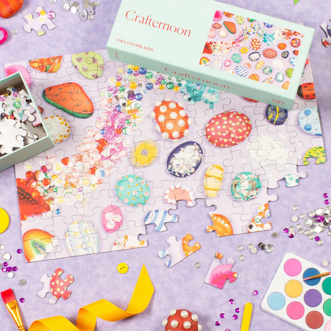 Colorful children's puzzle with a 'Crafternoon' box on a purple background