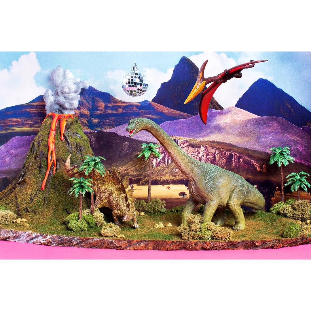 Dinosaur model scene with volcanoes, mountains, and a disco ball in the sky.