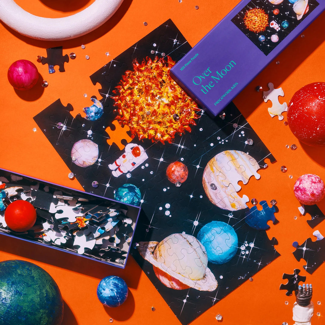 Space-themed puzzle set with planets and stars on an orange background