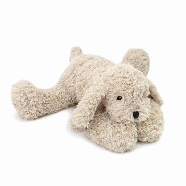 Plush toy dog lying on a white background