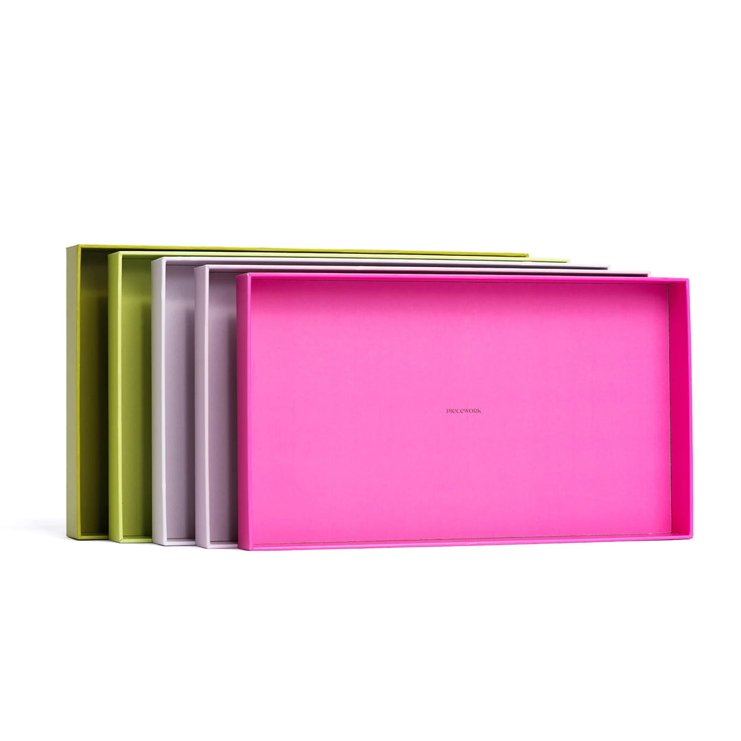 Colorful puzzle sorting trays on a white background