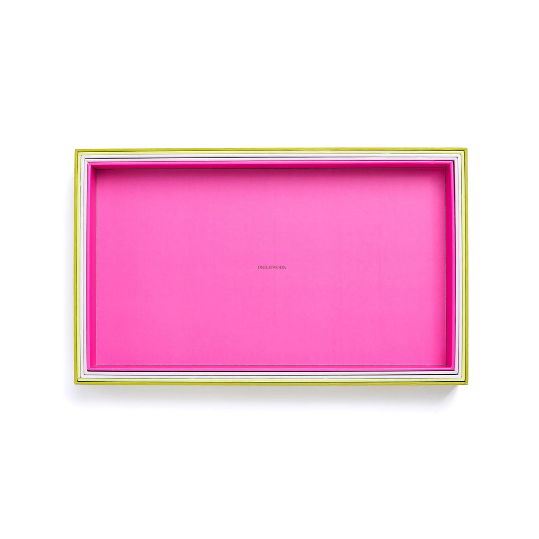 Nested puzzle trays on a white background