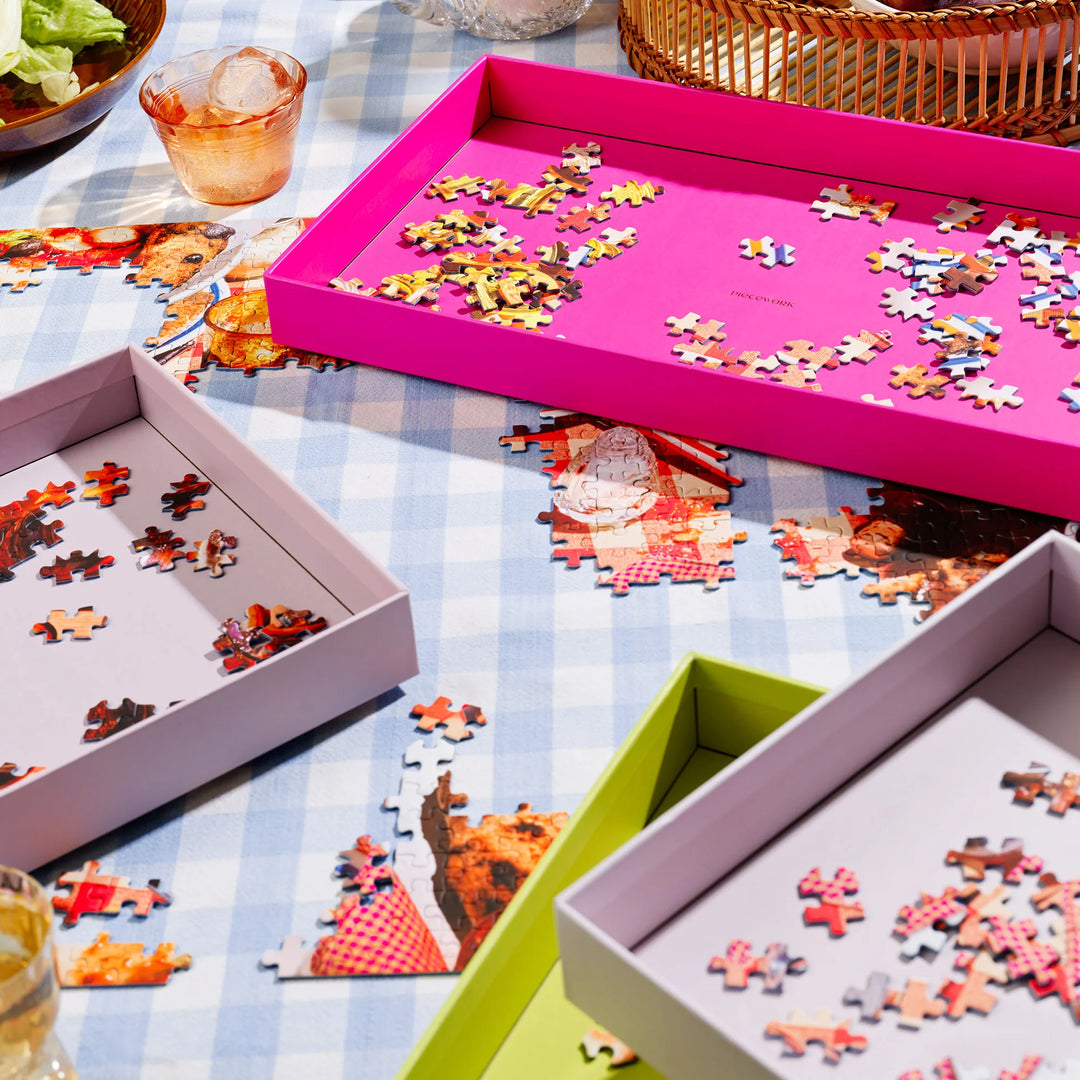 Puzzles in various boxes on a checkered tablecloth